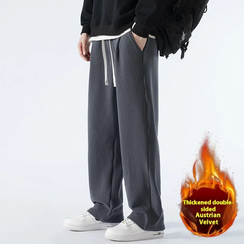 Men's apricot double-sided polar fleece winter trousers with a loose fit and drawstring waistband on a hanger.