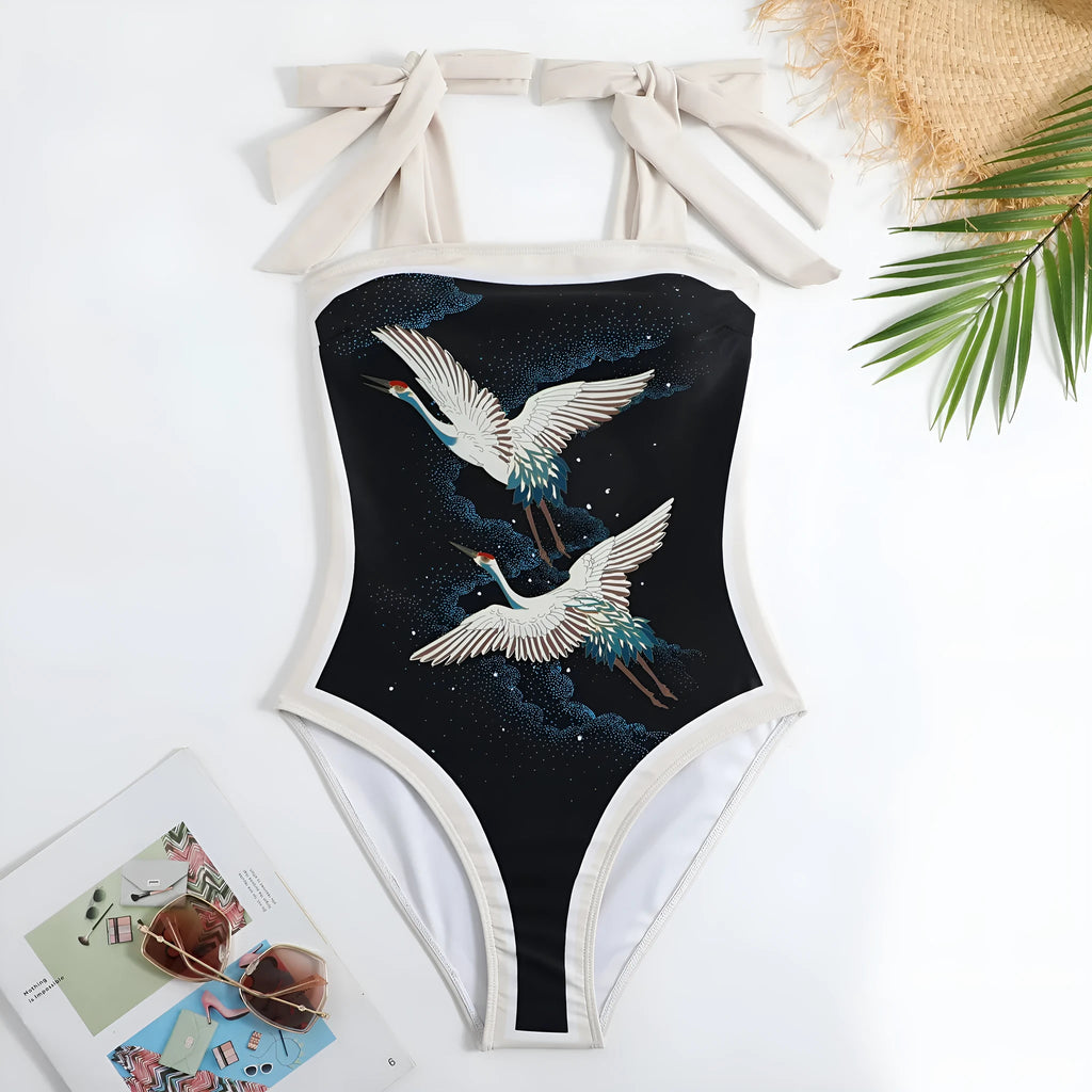 Retro women's one-piece swimsuit with a chiffon skirt in a floral pattern.