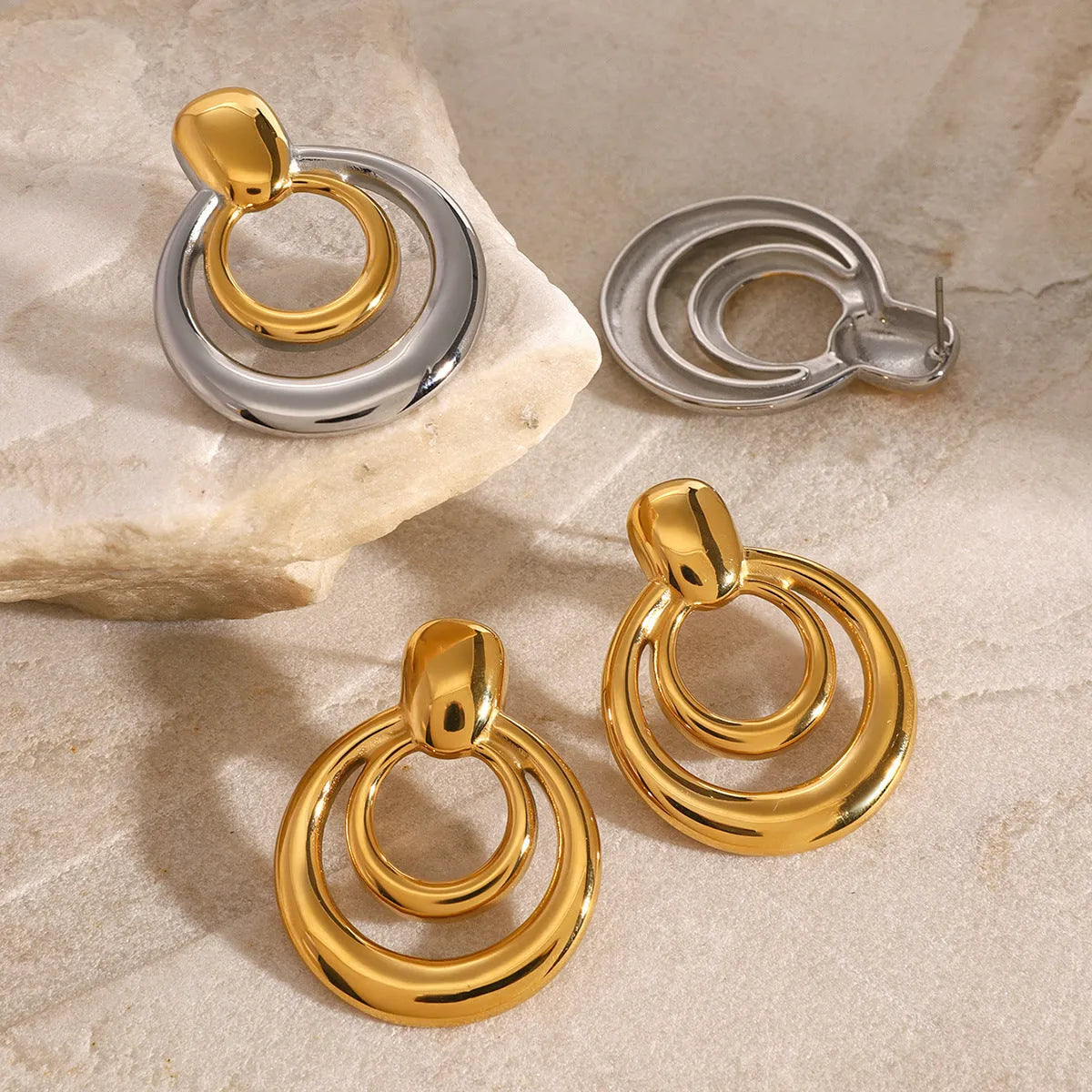 Round double layer hollow stud earrings with electroplated 18K gold finish in golden colour