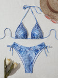Denim blue printed women's bikini set with strappy triangle top and matching bottoms on a neutral background.