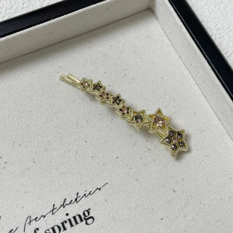 Gold colour alloy hair barrettes with broken clip design and five-pointed star decoration