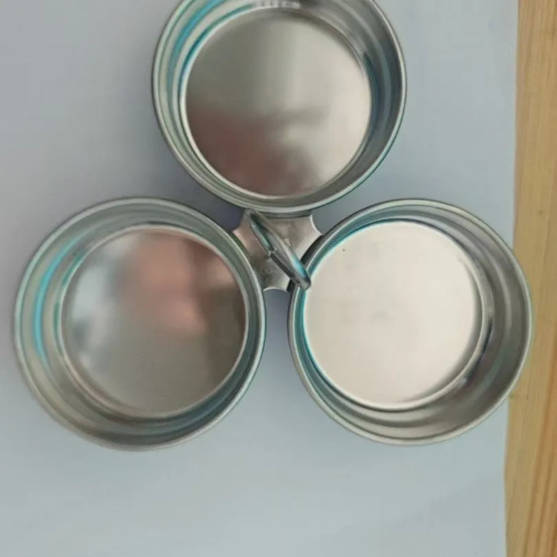 Small stainless steel heart-shaped egg steamer or round egg cooker for use on a hob.