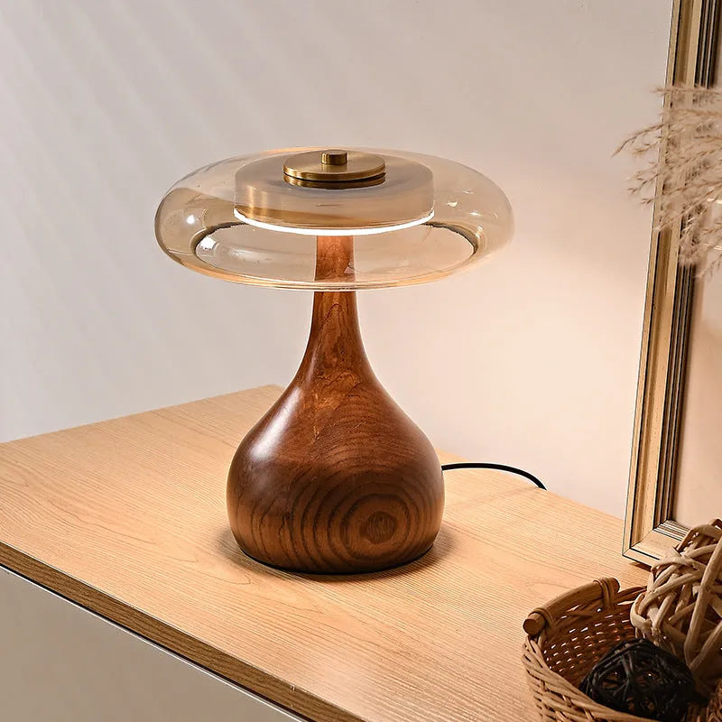 Solid ash wood bedside lamp with cognac shade and metal base on wooden table