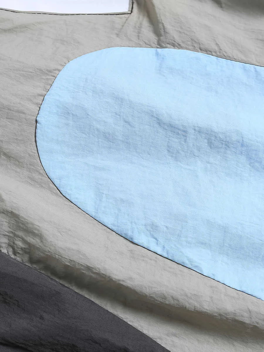Blue patchwork quick-drying shorts with loose straight-leg styling and micro-elastic waistband