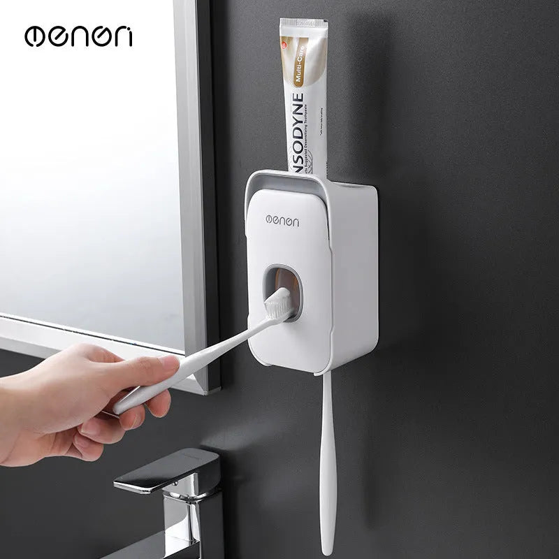 Automatic toothpaste dispenser in blue, grey, and pink colours made from ABS plastic.