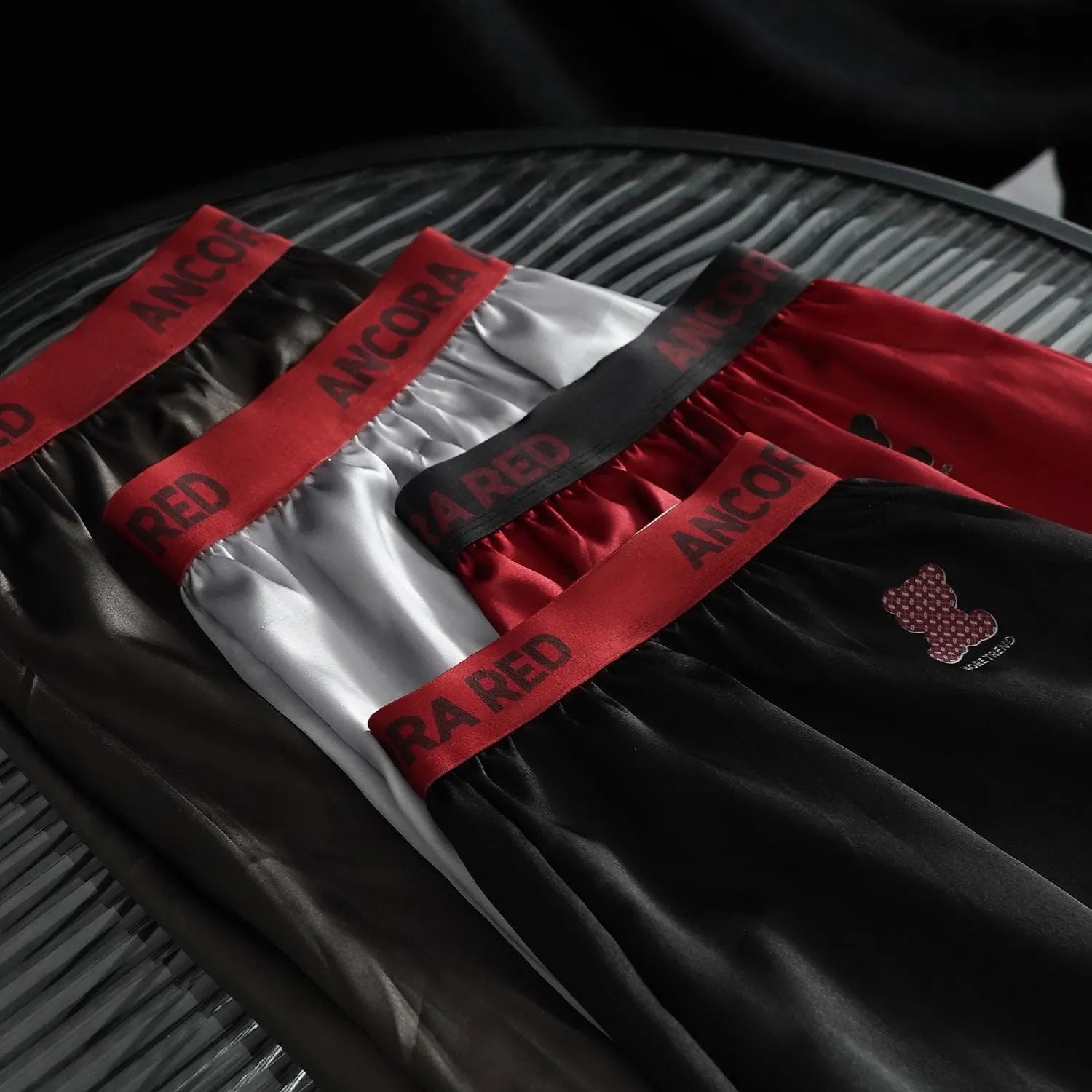 Solid colour men's boxer briefs in polyester fabric on a mid waist mannequin.