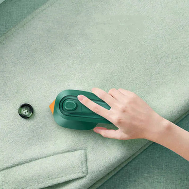 Dark green portable handheld hanging steam ironing machine with ceramic panel on a white background.
