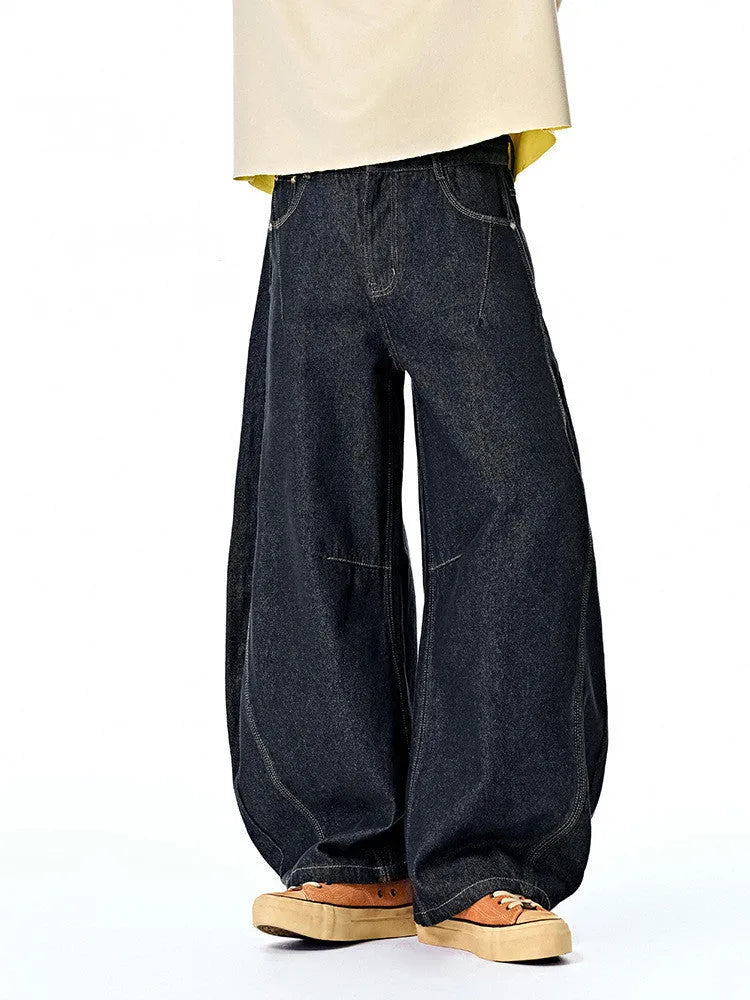 Men's original cow colour wide-leg denim trousers laid flat, showing mid-waist and full-length legs.