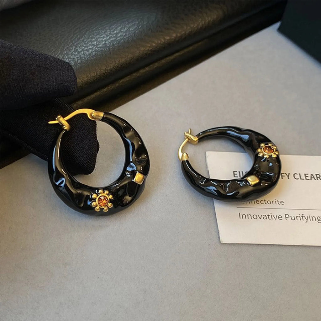 Retro style ear studs with dripping oil finish and rhinestone detailing in black and red colours