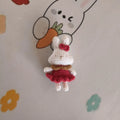 Hand-crocheted wool rabbit key chain pendant with key chain attachment on a soft surface