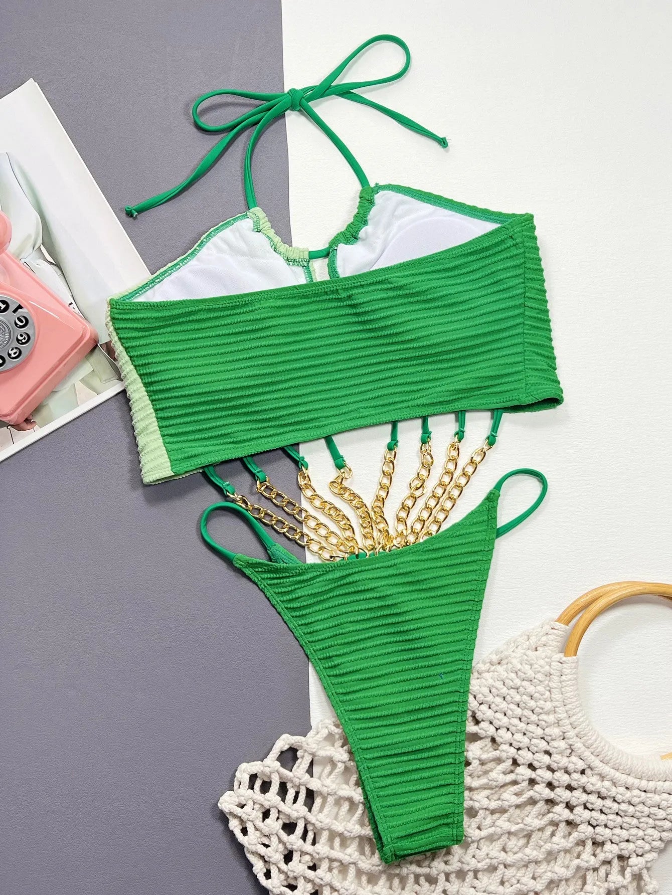 Green one-piece swimsuit for women with a hollow cut-out design on the front.
