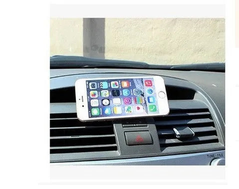 Magnetic car phone mount with paste base in black holding a Samsung phone on dashboard