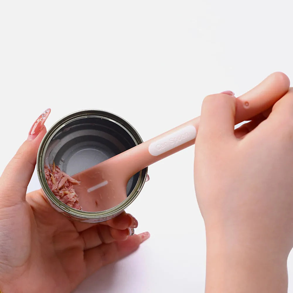 Green long-handled TPR spoon for scooping pet canned food on a white background