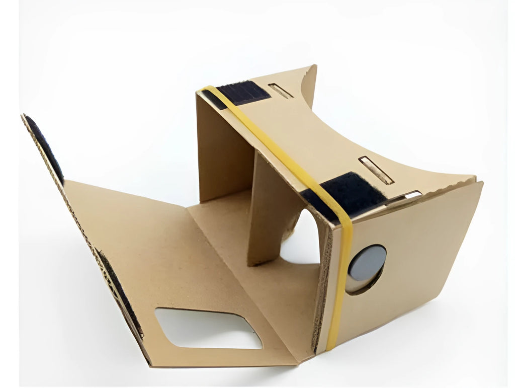 Pink and white cardboard VR headset for smartphones with adjustable straps and 3D lenses.