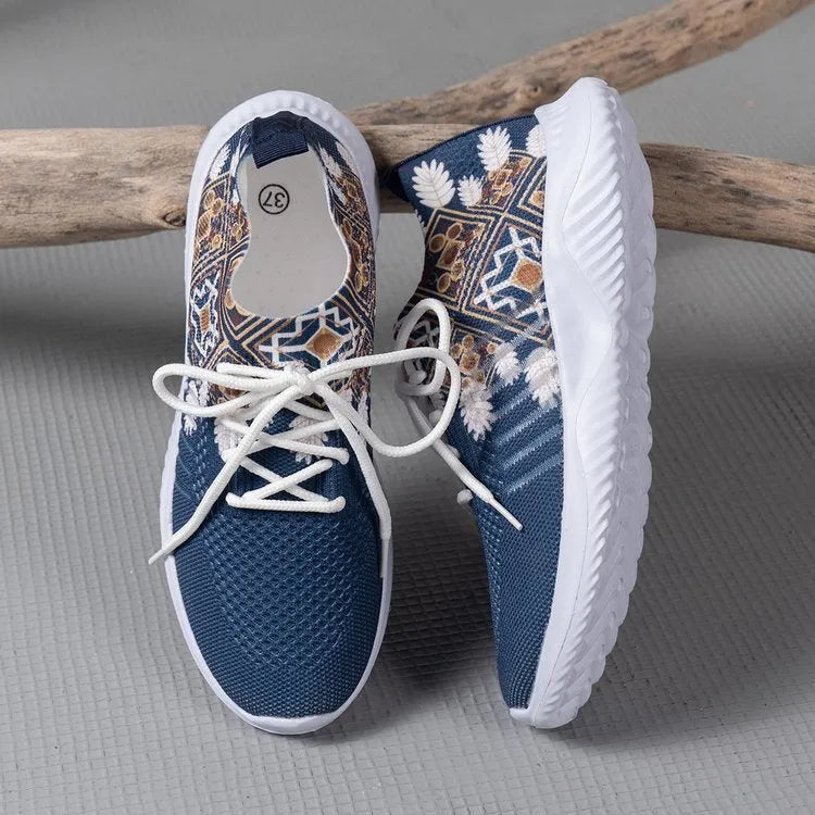 Women's woven flat shoes in green with printed totem detail, mesh upper, rubber sole, and front lace-up closure