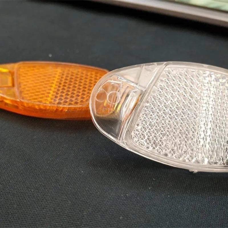 Yellow and white plastic bicycle spoke reflectors measuring 7.2cm for night safety