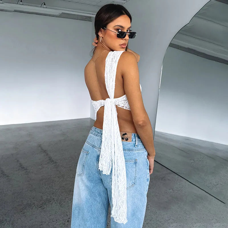 Women's apricot backless sleeveless top with lace trim and asymmetrical sloped neckline.