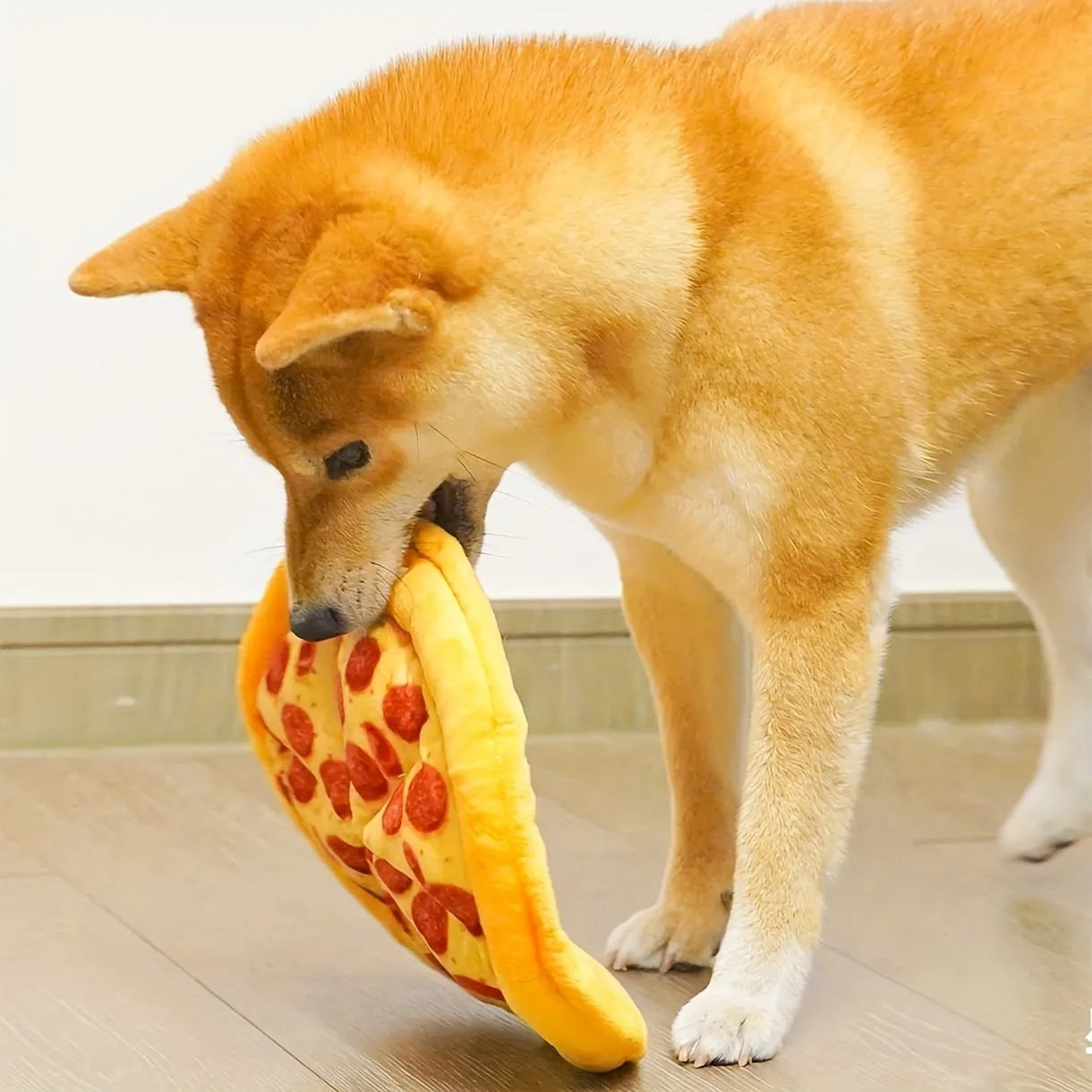 Yellow plush pizza-shaped dog toy with a squeaker inside for chewing and interactive play.