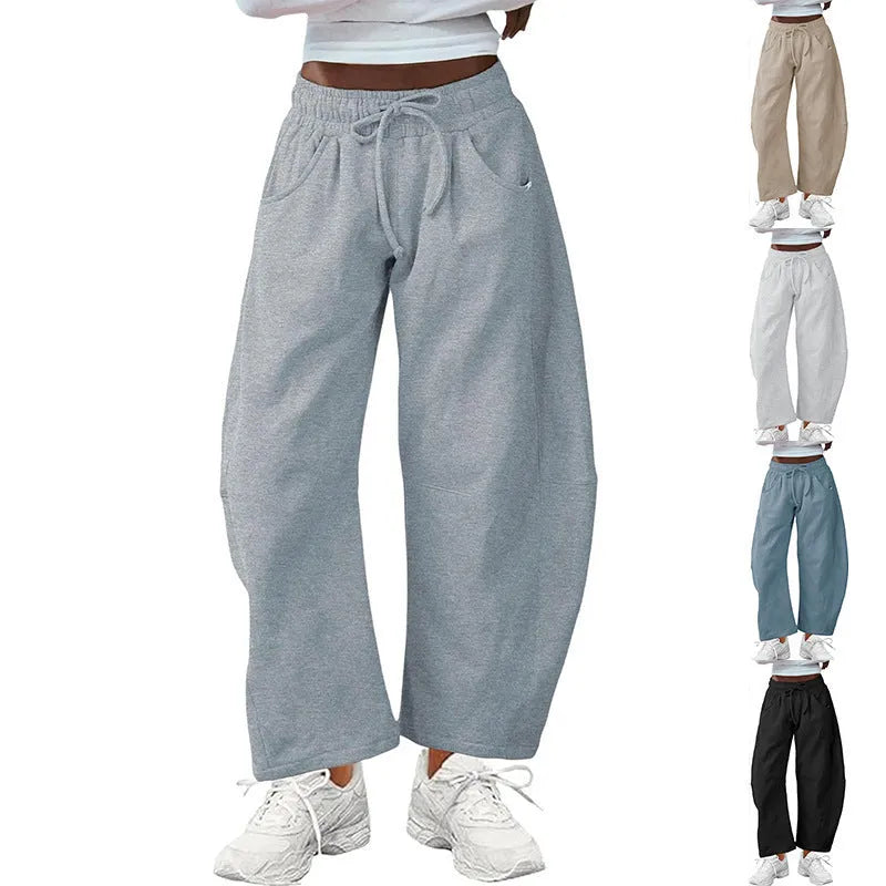 Loose cropped sweatpants with elastic drawstring waist and pockets in street fashion styling