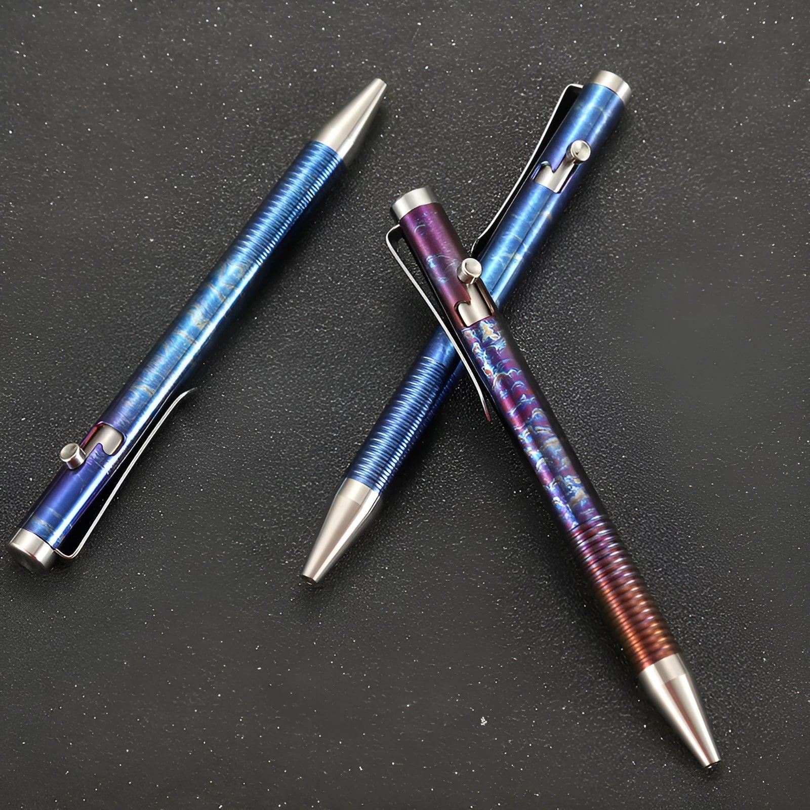 Titanium alloy gun bolt handle ball pen with magic colour phantom finish on a desk.