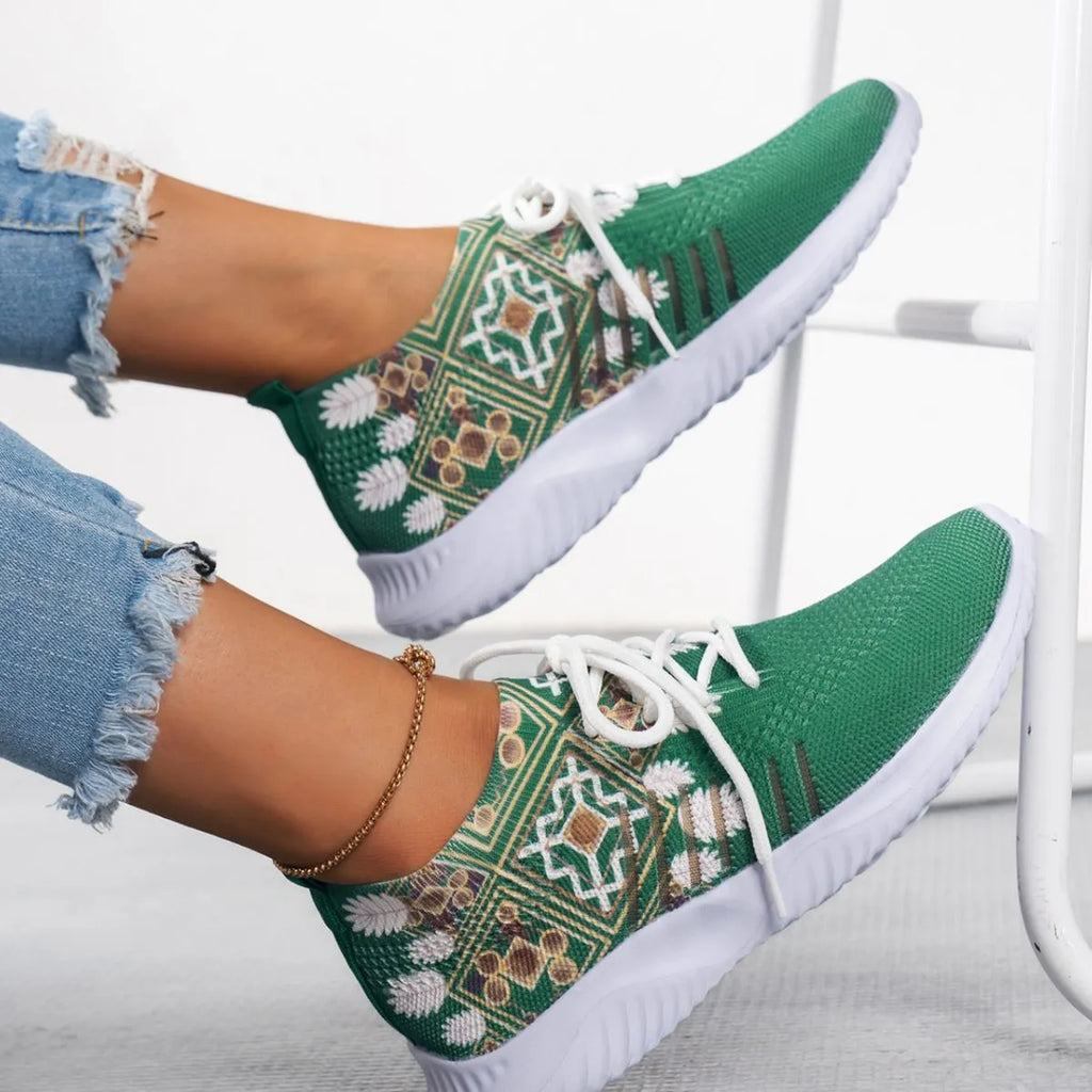 Women's woven flat shoes in green with printed totem detail, mesh upper, rubber sole, and front lace-up closure
