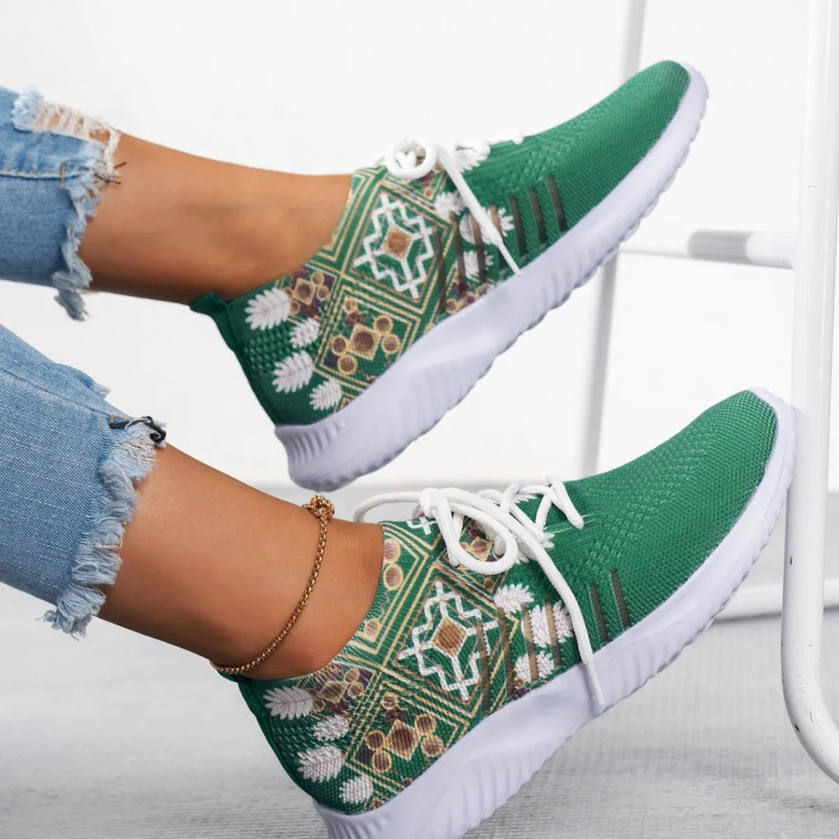Women's woven flat shoes in green with printed totem detail, mesh upper, rubber sole, and front lace-up closure