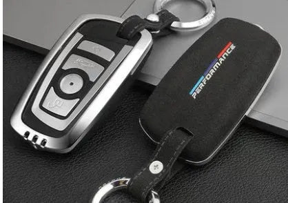 Suede key case with zinc alloy front frame in Classic Black, Charming Red, and Saddle Brown colour options