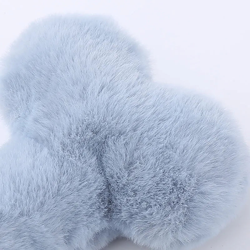 Blue plush bone dog toy with squeaker on a plain background.