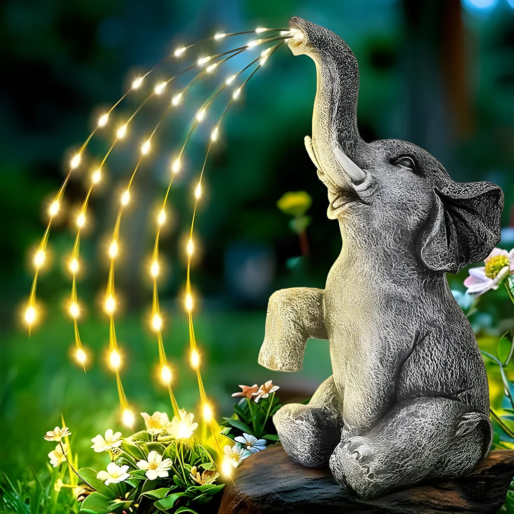 Outdoor resin elephant statue sculpture with LED light strip on garden lawn.