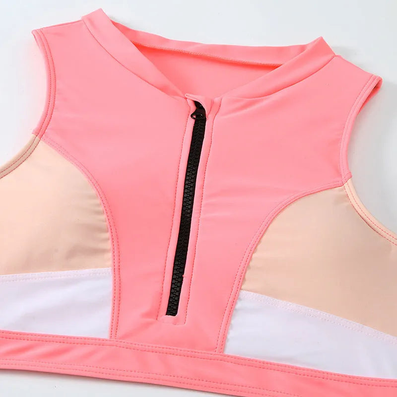 Pink high-waist bikini swimsuit with briefs style shorts and sleeveless top on a neutral background.