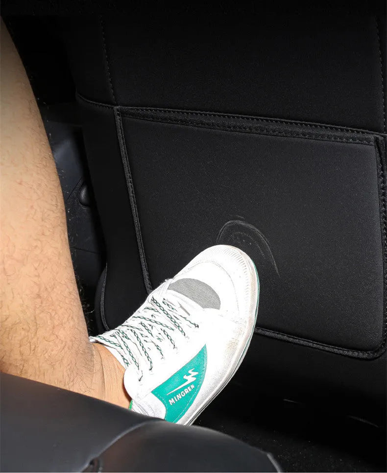 Set of two black leather rear seat anti kick pads with a storage pocket.