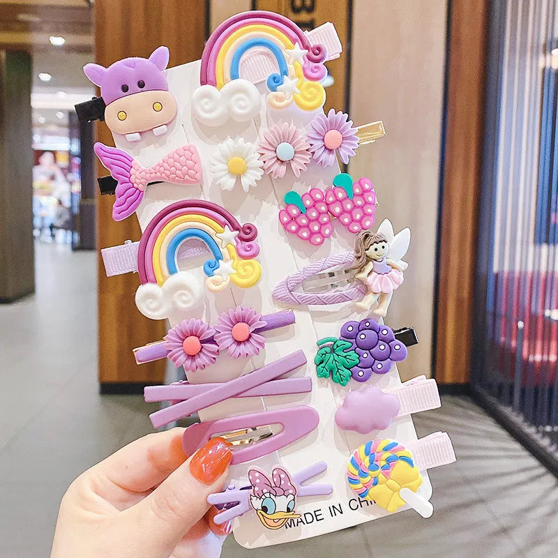 14-piece toddler hair accessories set on display including rainbow barrettes, fruit clips, and butterfly pins in bright colours