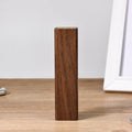Portable power bank with brown walnut wood shell and USB port on a light background