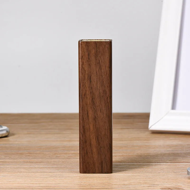Portable power bank with brown walnut wood shell and USB port on a light background