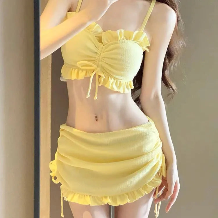 Women's solid colour milk silk bikini swimsuit set with top and pants.
