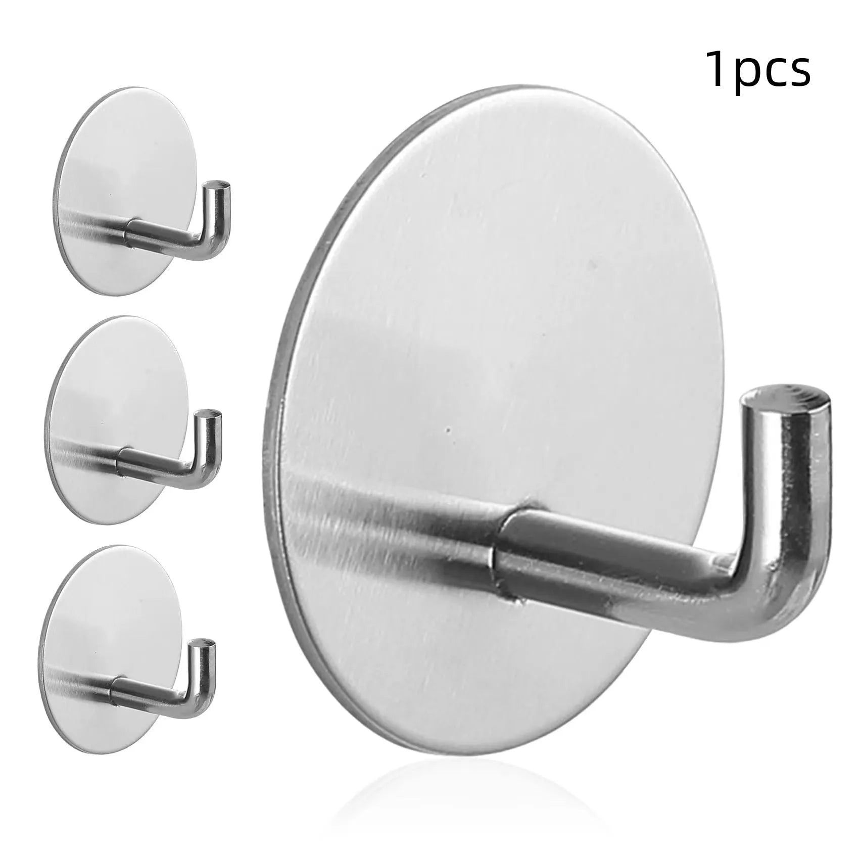 Stainless steel self-adhesive wall hook in black and polished finishes, shown with a towel hanging from it.
