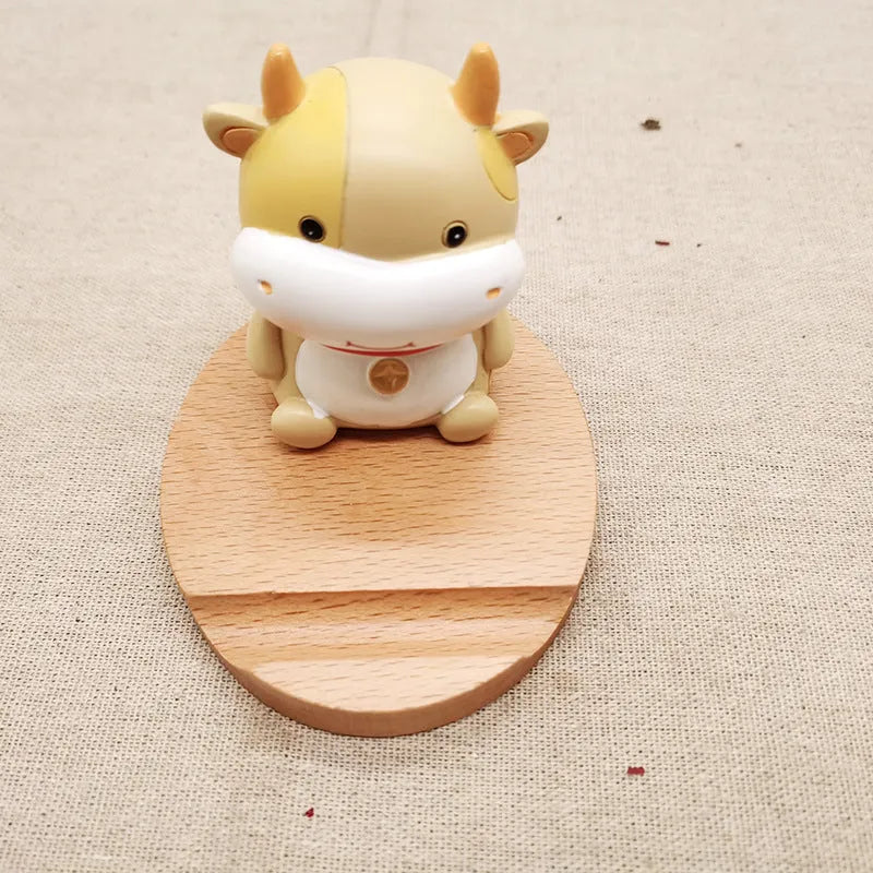 Beech wood mobile phone holder with resin animal design and coin slot