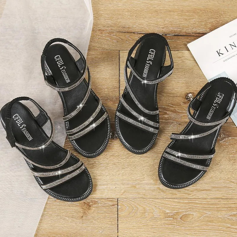Women's gold casual flat sandals with rhinestone detail and elastic band on a rubber sole.