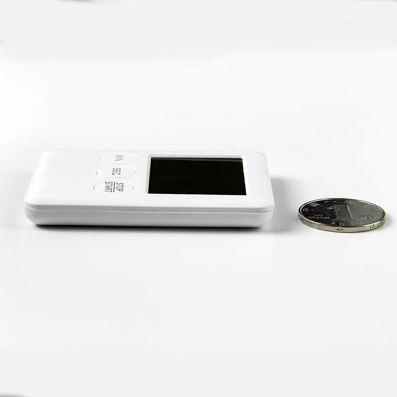 Black and white digital kitchen timer with magnetic back showing countdown display