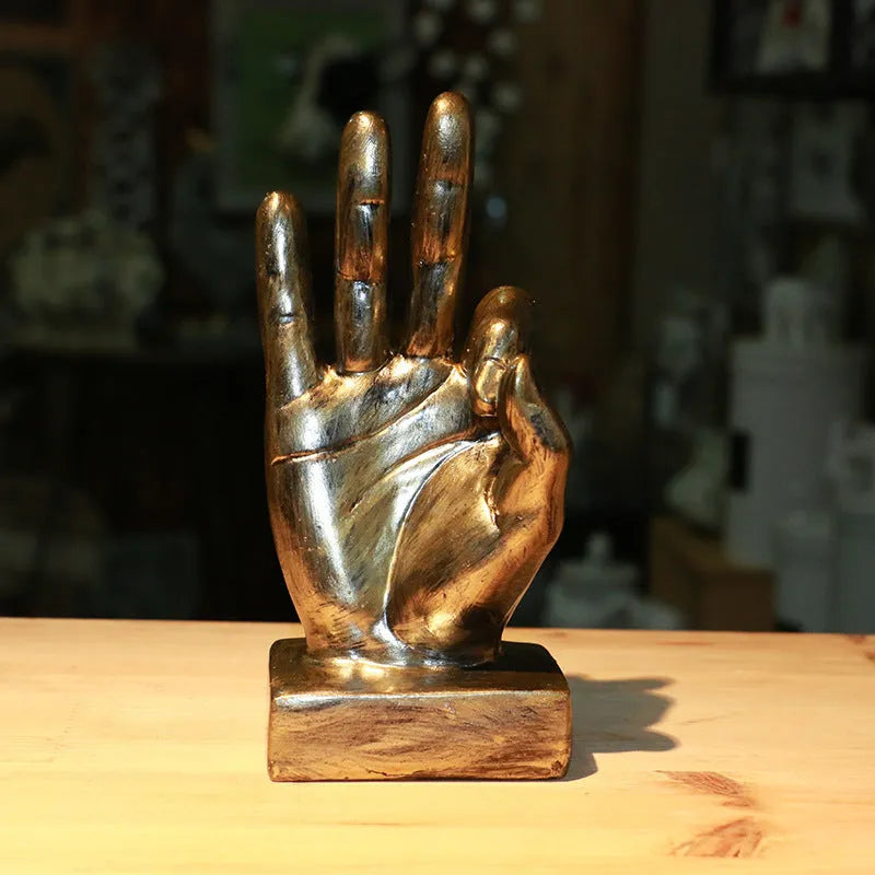 Resin gesture ornament in silver OK hand sign on desktop, blessing home decoration