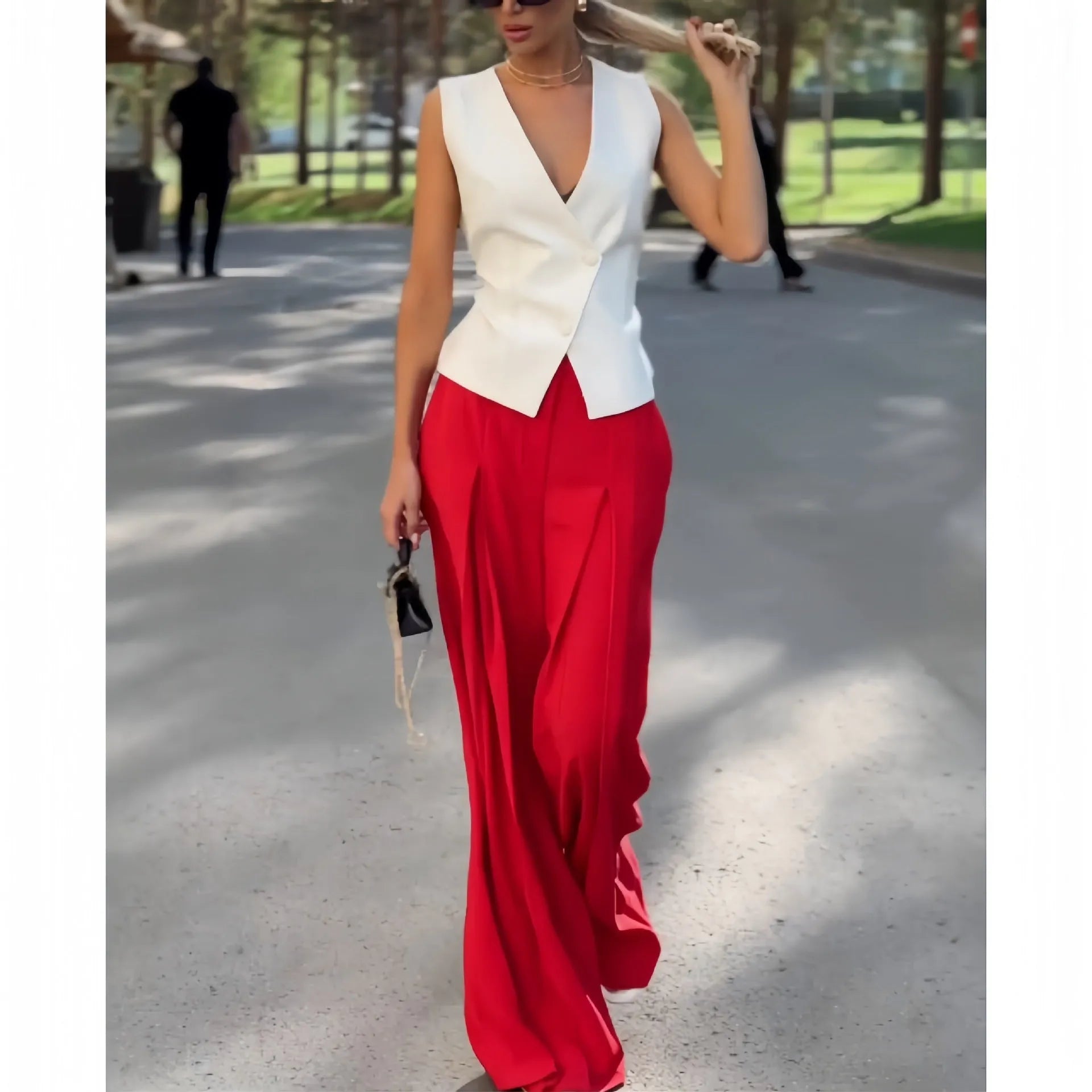 Women's beige deep V-neck sleeveless top and high waist wide leg pants two-piece set on model