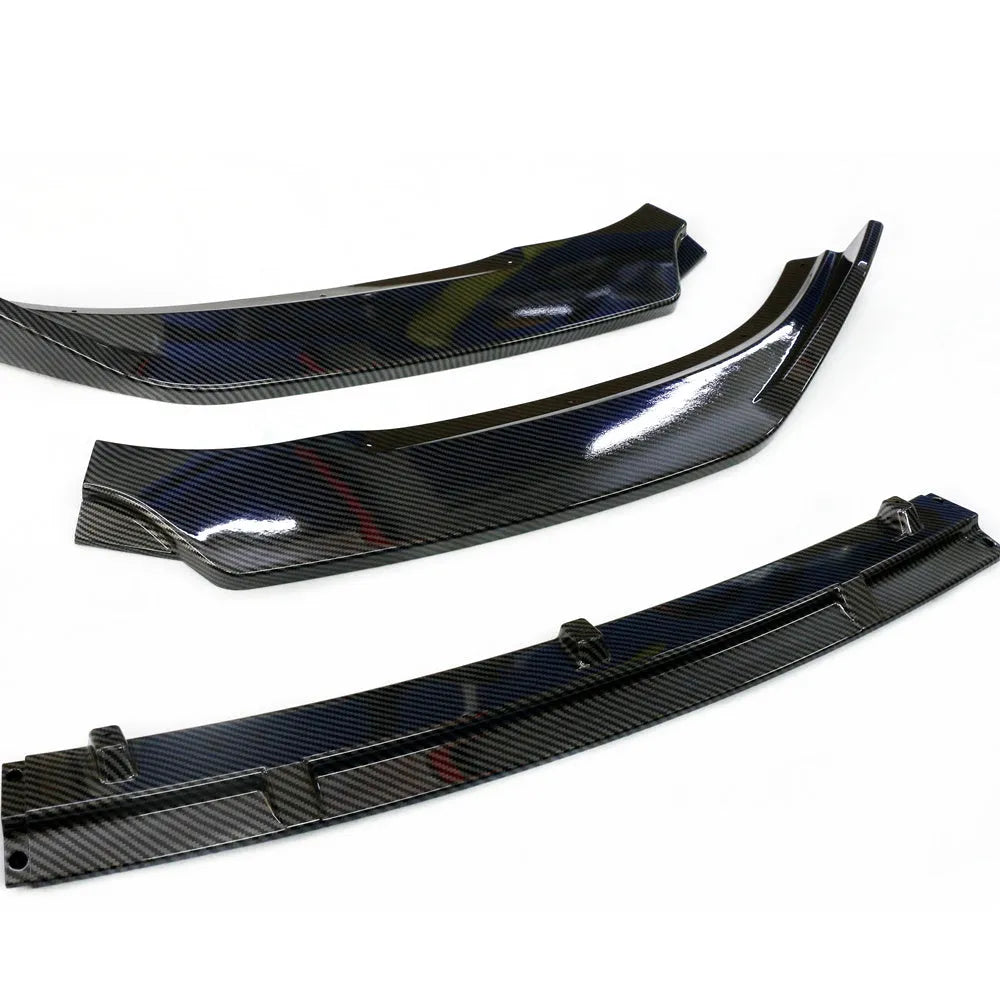 Audi A1 8X front splitter retrofit kit with three-section design in black Unksera pattern.