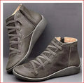 Women's black casual flat wedge heel ankle boots with round toe and rubber sole.