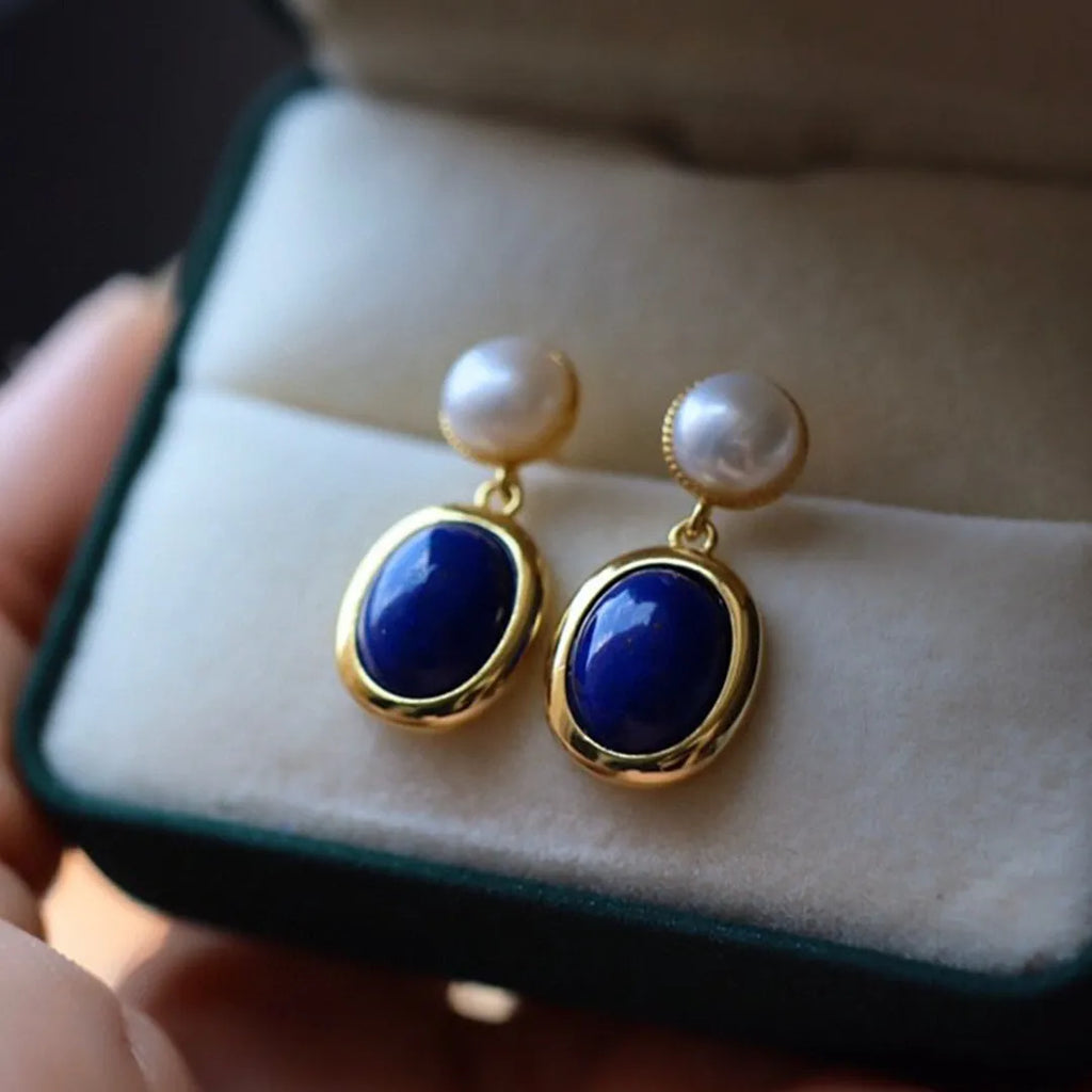 A pair of simple 925 silver earrings with blue lapis lazuli pearls and auspicious patterns.