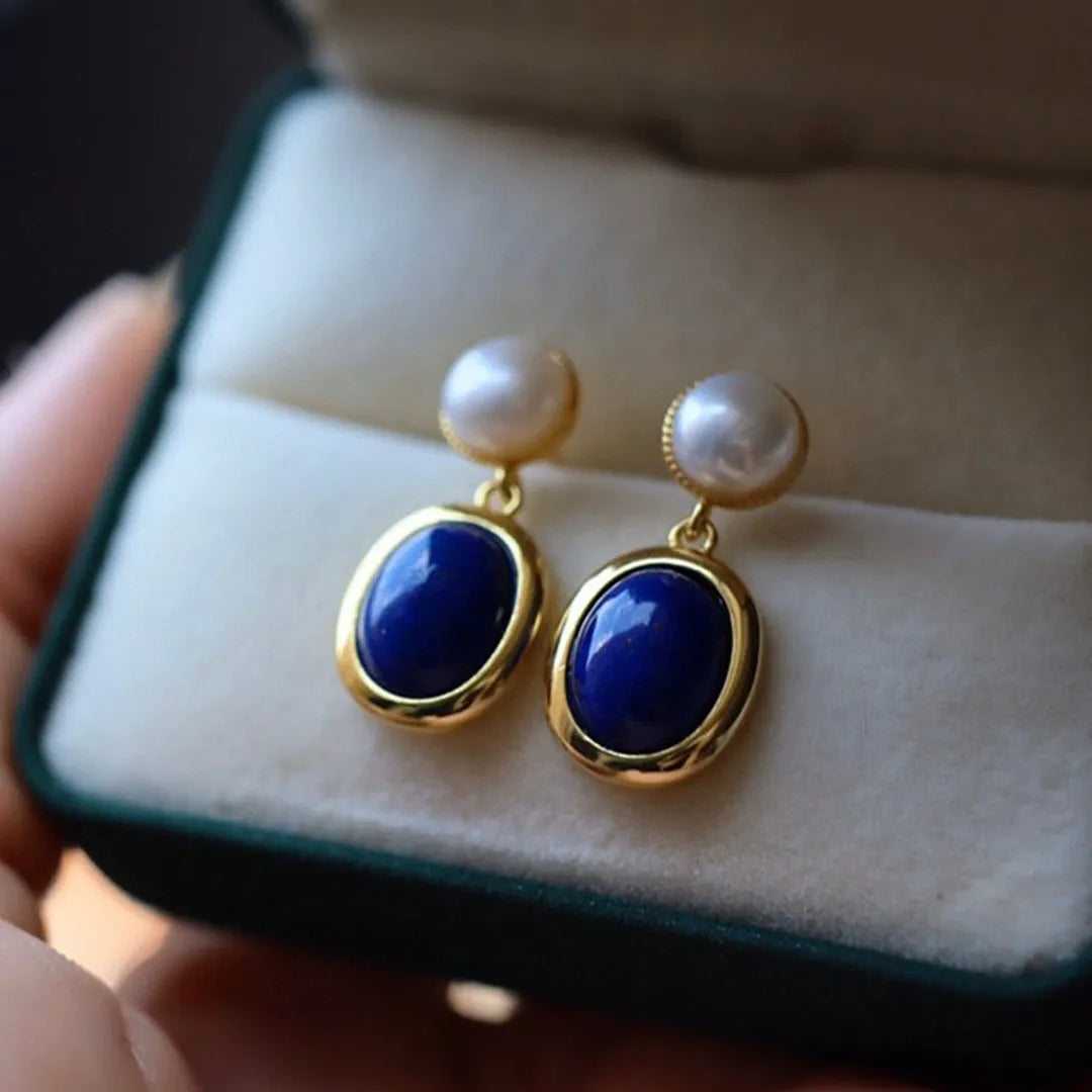 A pair of simple 925 silver earrings with blue lapis lazuli pearls and auspicious patterns.
