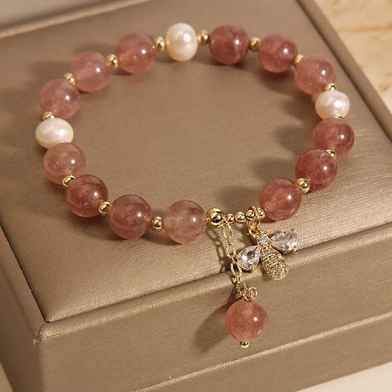 Women's beaded bracelet with strawberry quartz stones, freshwater pearls, and zircon accents on alloy.