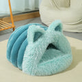 Plush cat and dog bed with raised collar and cat ear decoration in blue, size M