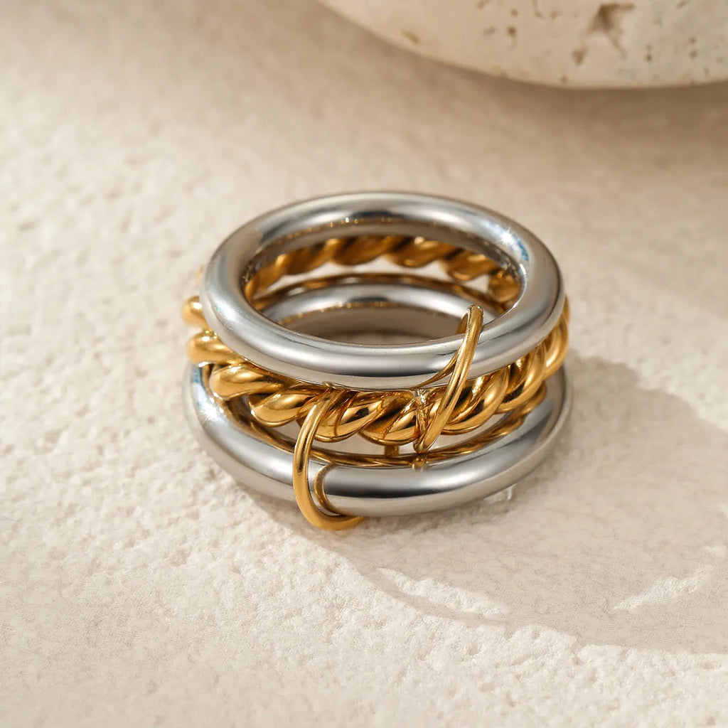Gold plated stainless steel stacked ring set for women in an exaggerated free-size design.
