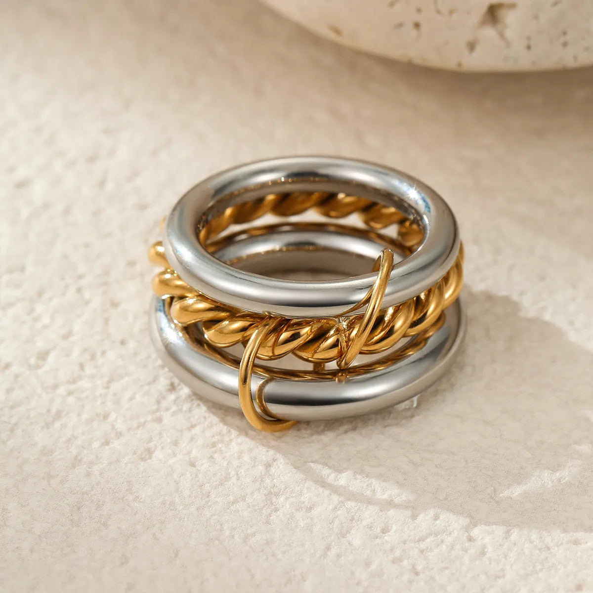 Gold plated stainless steel stacked ring set for women in an exaggerated free-size design.