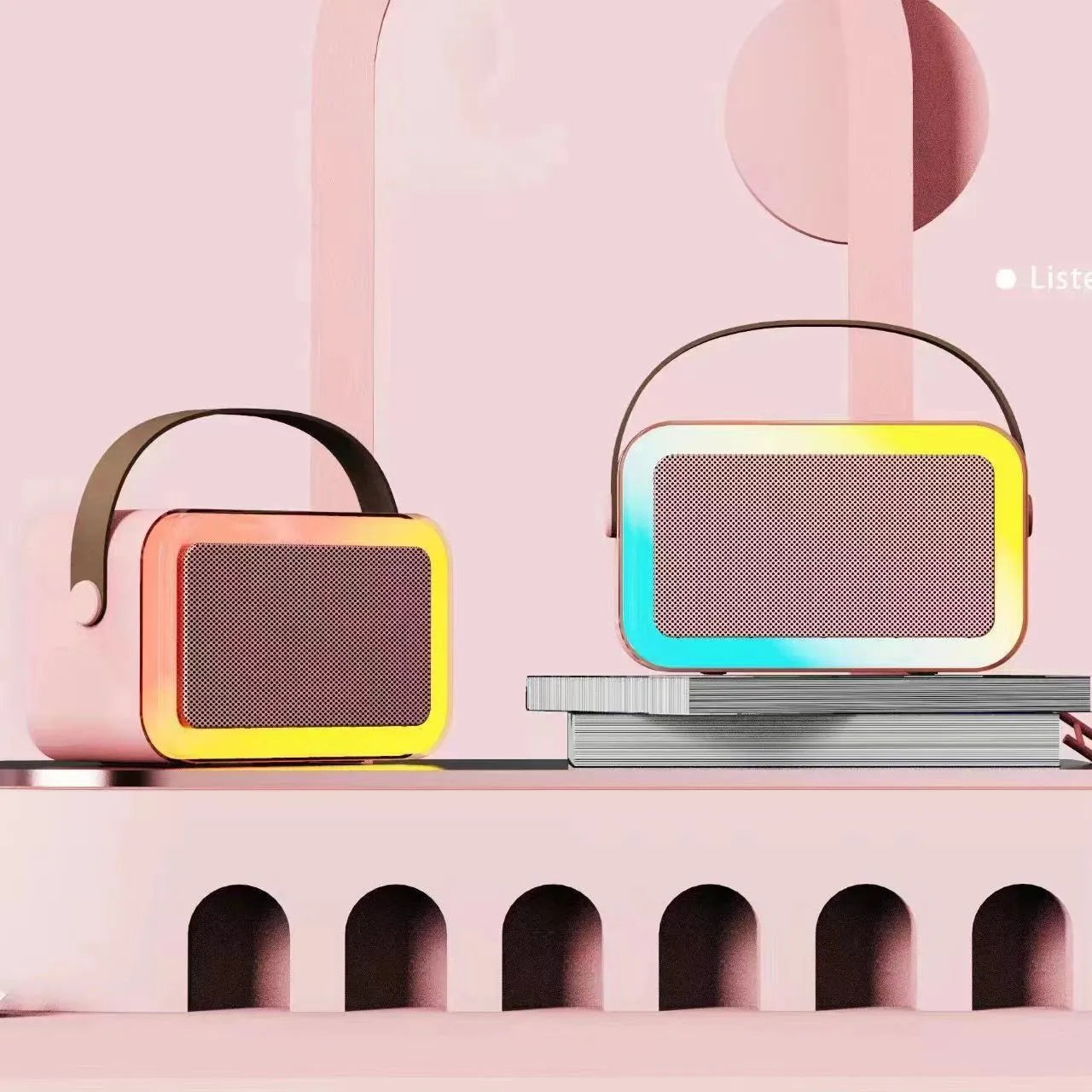 Pink portable Bluetooth karaoke speaker with microphone and coloured LED lights on a table.